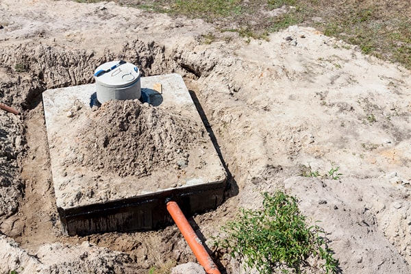 before septic tank pumping, it's important to uncover and clear the area around the access point to the tank for easy access for the professionals